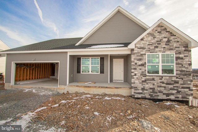 view of front of property with a porch and a garage