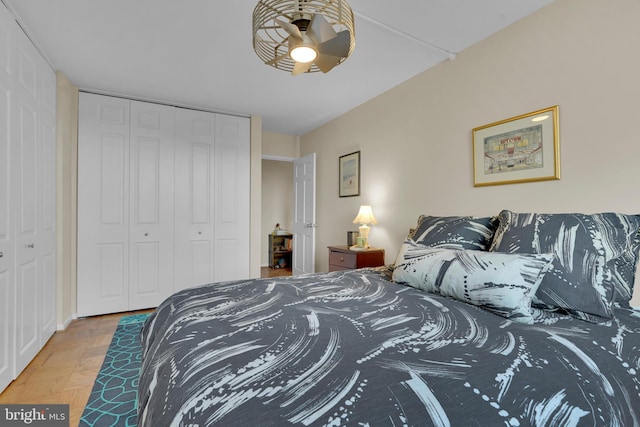 bedroom with ceiling fan, a closet, and hardwood / wood-style flooring