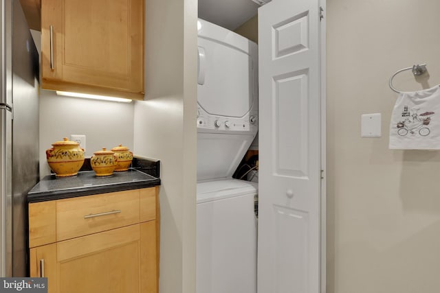 laundry area with stacked washer and dryer