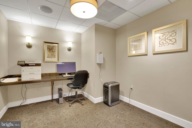 carpeted office space with a drop ceiling