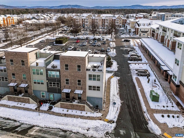 snowy aerial view featuring a mountain view