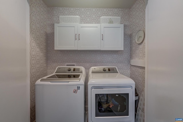 laundry area with cabinets and independent washer and dryer