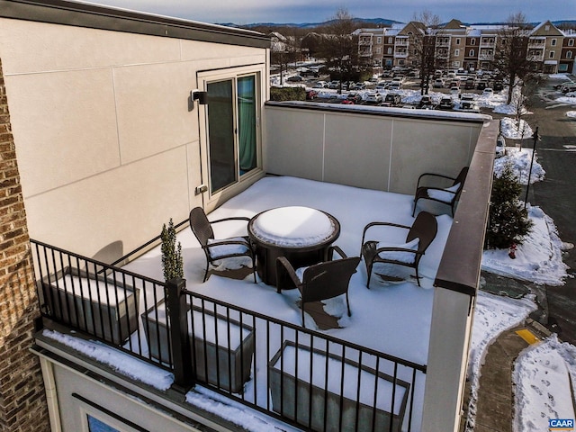 view of snow covered back of property