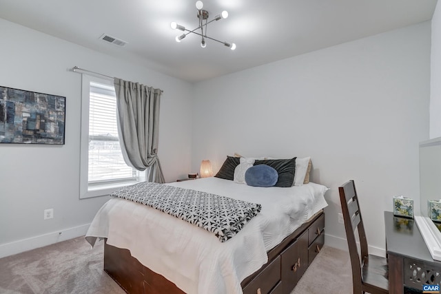 carpeted bedroom featuring a notable chandelier