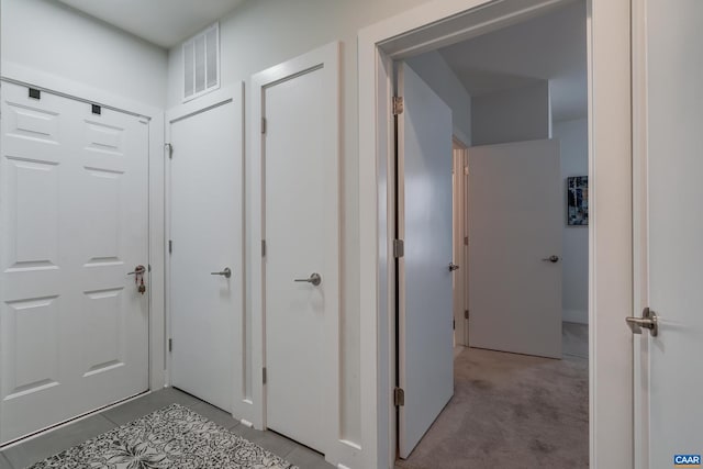 hallway with light colored carpet