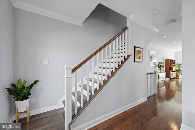 staircase featuring crown molding and hardwood / wood-style flooring