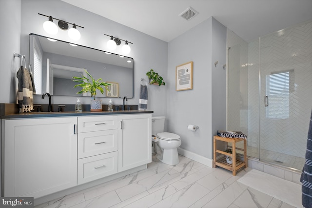 bathroom featuring walk in shower, vanity, and toilet