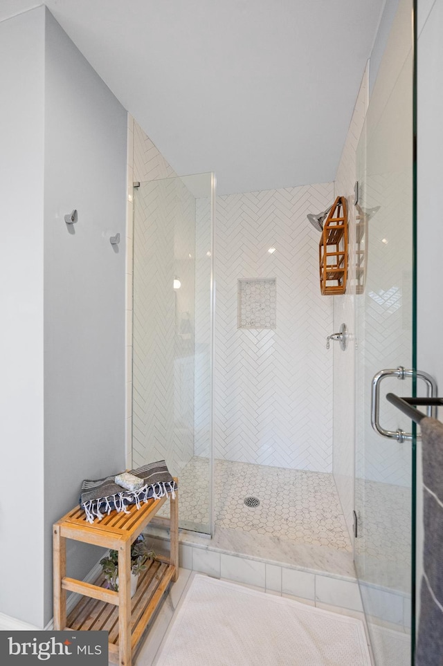 bathroom with a shower with shower door