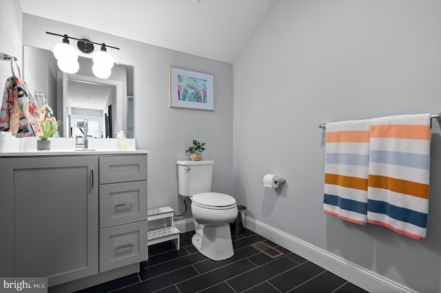 bathroom featuring toilet and vanity