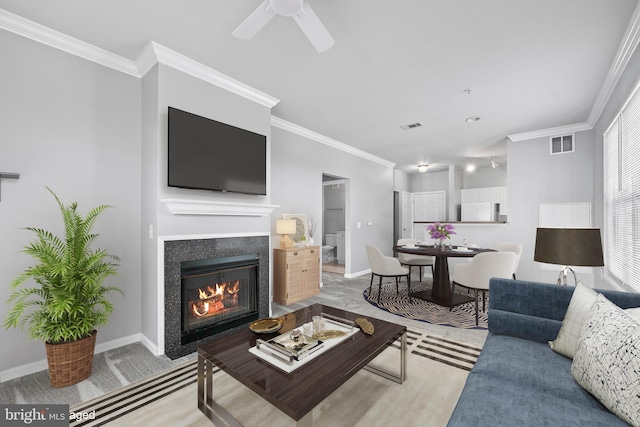 living room featuring ceiling fan and ornamental molding