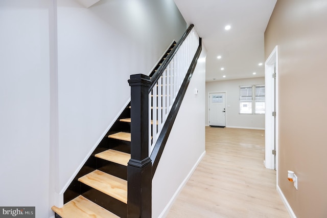 stairs featuring hardwood / wood-style floors