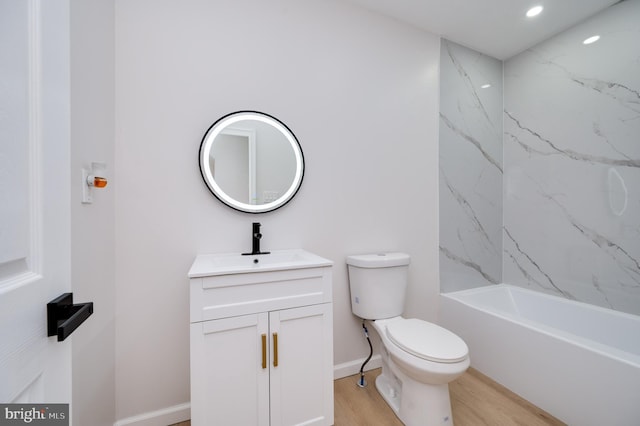 full bathroom with tiled shower / bath combo, toilet, vanity, and hardwood / wood-style flooring