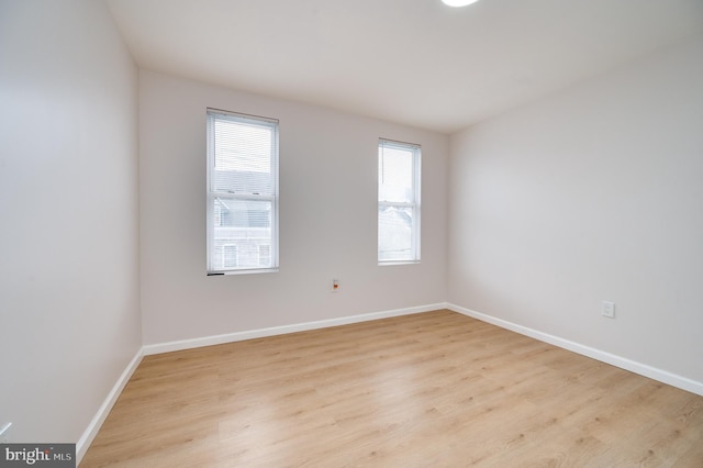 unfurnished room with light hardwood / wood-style floors and a healthy amount of sunlight