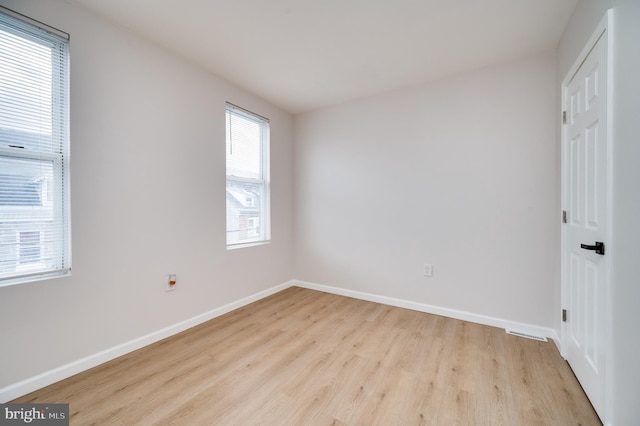 spare room featuring light hardwood / wood-style flooring