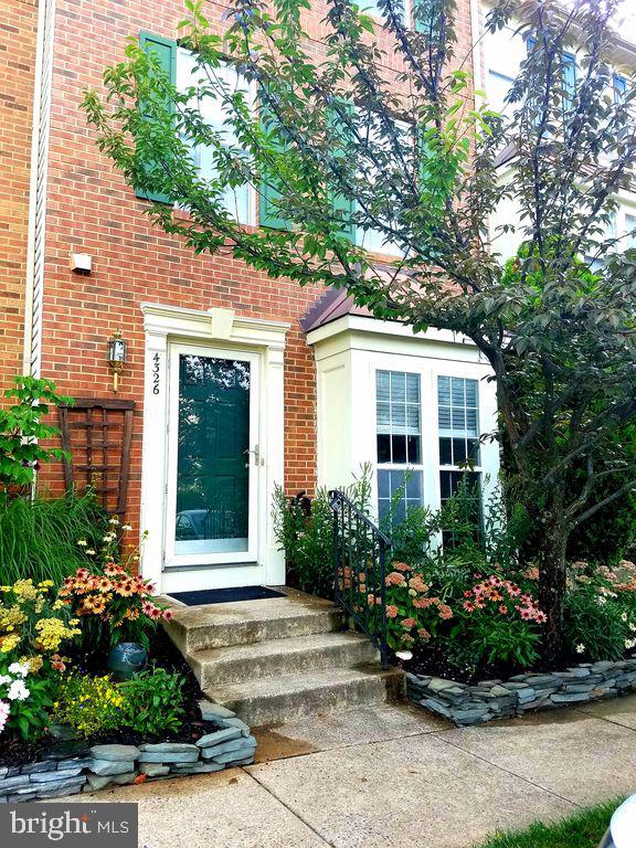 view of exterior entry with brick siding