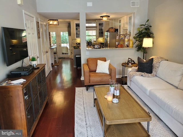 living room featuring dark wood-type flooring and french doors