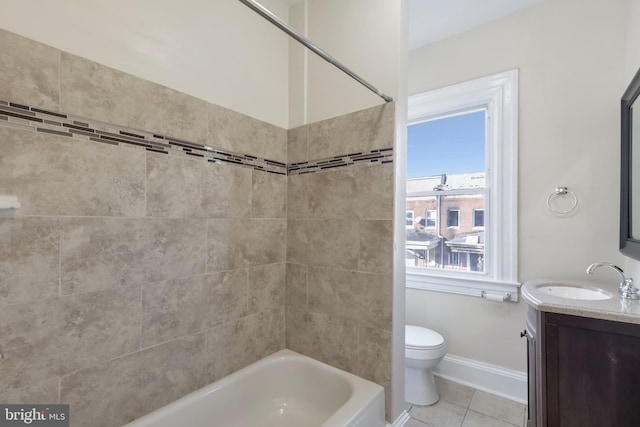 full bathroom featuring toilet, vanity, tile patterned floors, and tiled shower / bath