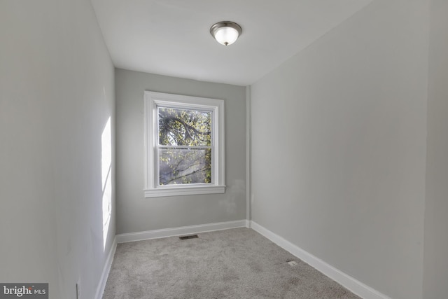 unfurnished room with light colored carpet