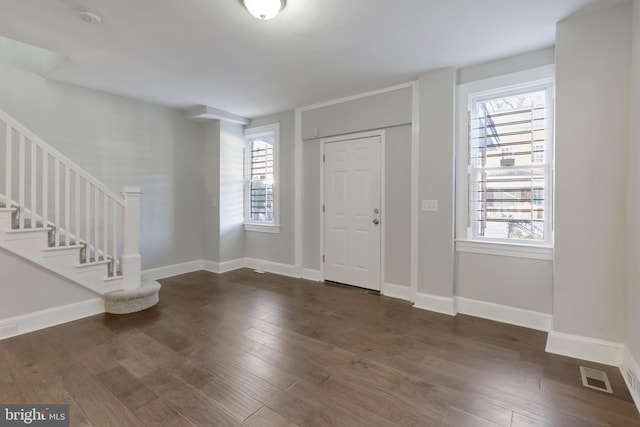 entryway with dark hardwood / wood-style floors