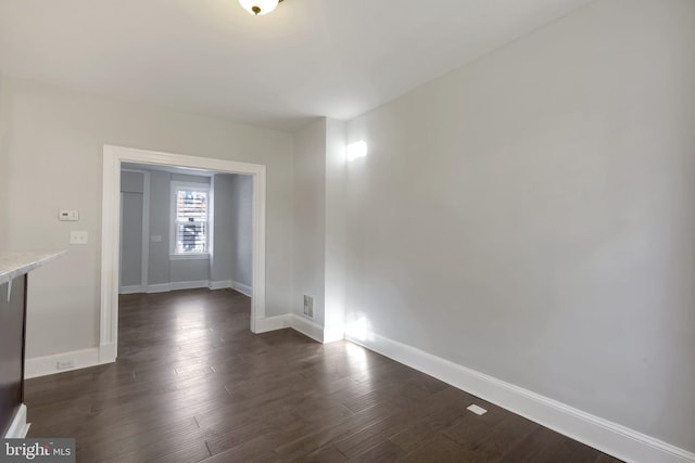 unfurnished room featuring dark hardwood / wood-style floors