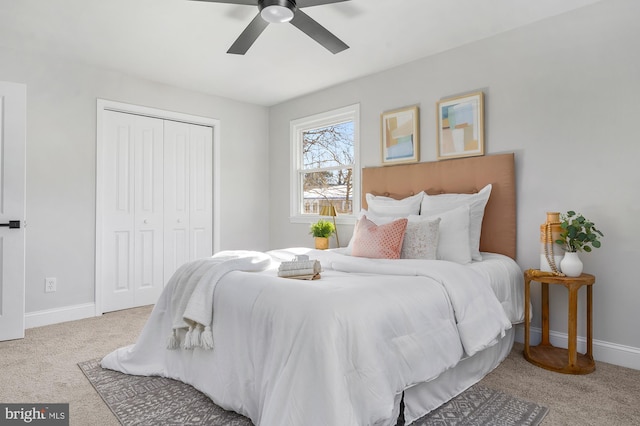 carpeted bedroom featuring ceiling fan and a closet