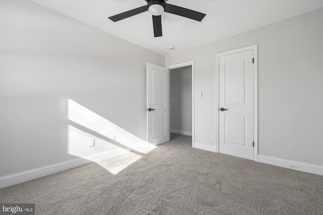 unfurnished room with ceiling fan and carpet floors