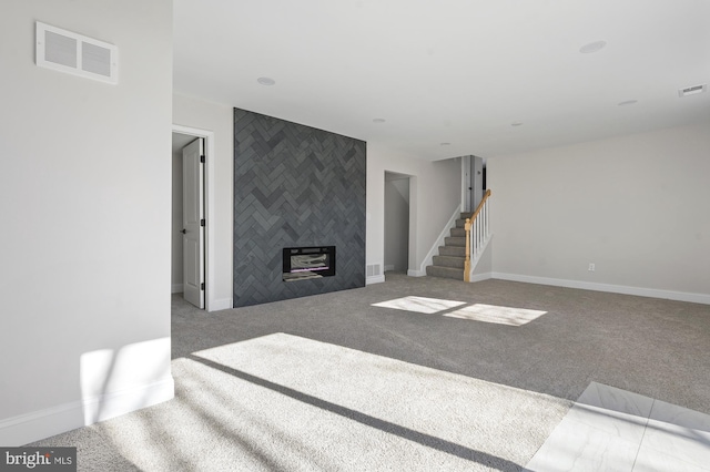 living room with light carpet and a tiled fireplace