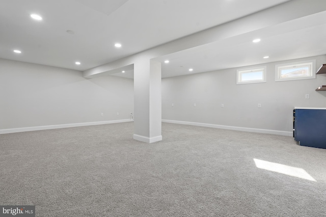 basement featuring light carpet