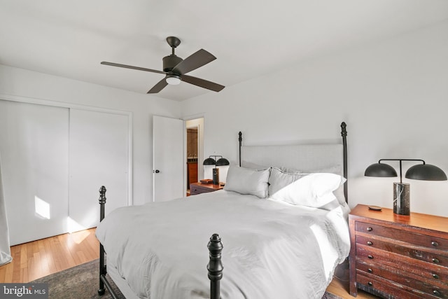 bedroom with a ceiling fan, a closet, and wood finished floors