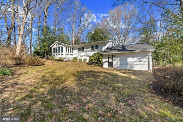 view of front of home with a front yard and a sunroom