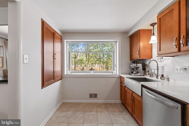 kitchen with visible vents, brown cabinets, and stainless steel dishwasher