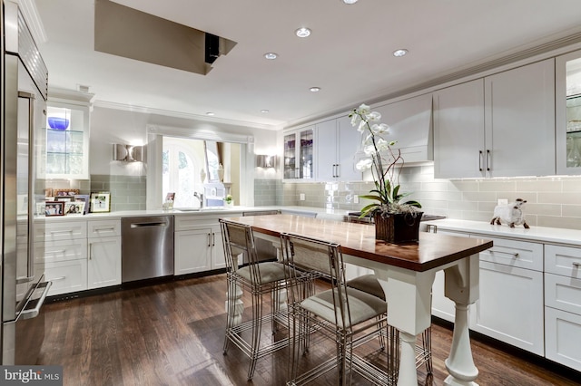 kitchen with stainless steel appliances, decorative backsplash, dark hardwood / wood-style flooring, and white cabinets