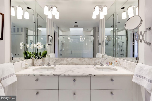 bathroom featuring an enclosed shower and vanity