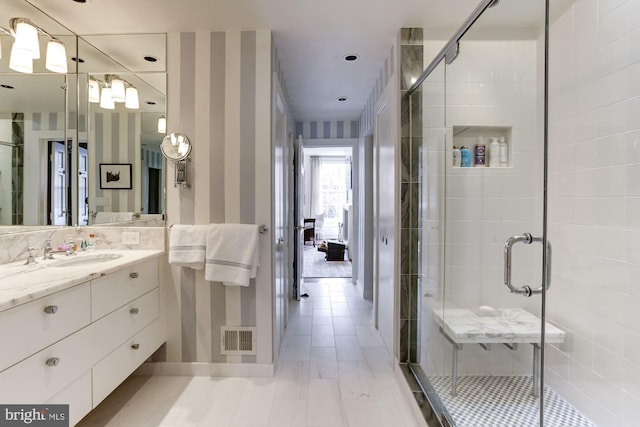 bathroom with an enclosed shower and vanity