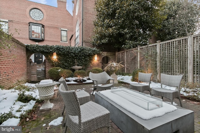 snow covered patio featuring an outdoor hangout area