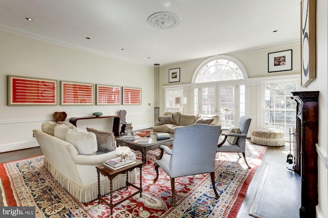 living room with light hardwood / wood-style floors and crown molding