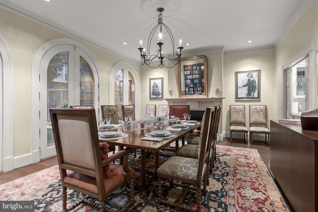 dining area with french doors, hardwood / wood-style floors, ornamental molding, and a chandelier