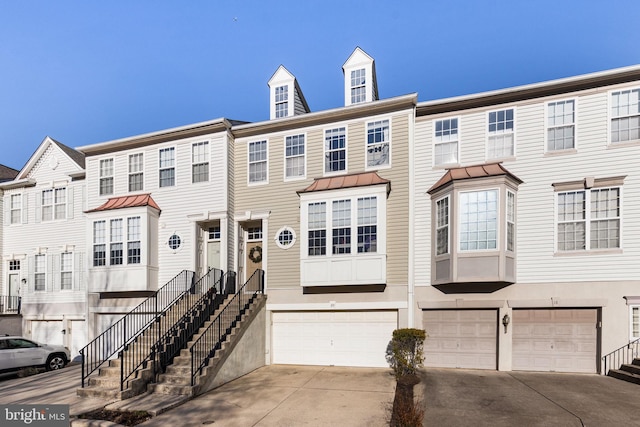 townhome / multi-family property featuring a garage