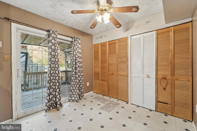 entrance foyer featuring ceiling fan and a textured ceiling