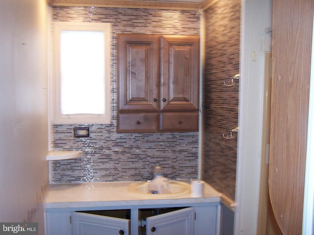 interior space featuring vanity and backsplash