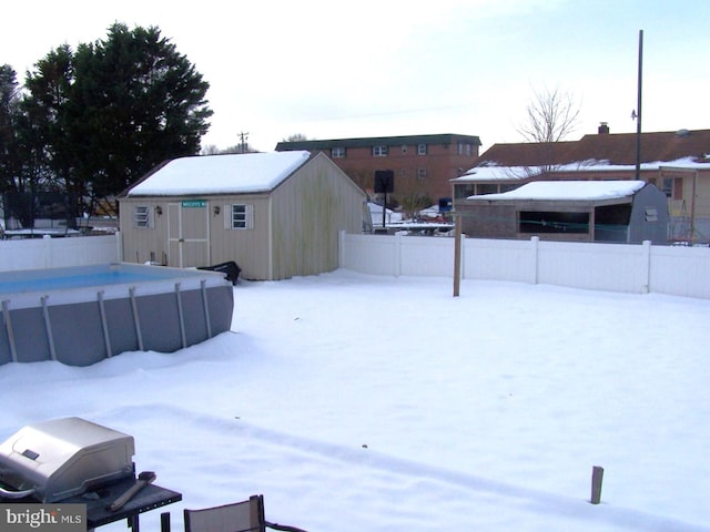 yard covered in snow with an outdoor structure