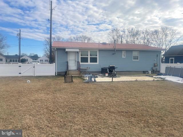 back of property with a patio and a lawn