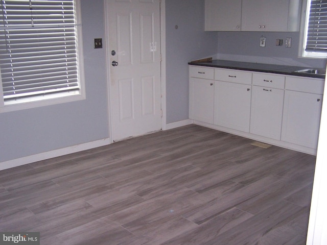 kitchen featuring dark hardwood / wood-style floors and white cabinets