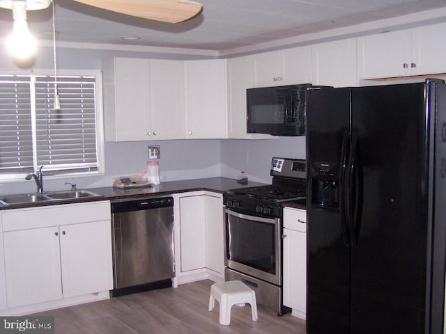 kitchen with white cabinetry, sink, black appliances, and light wood-type flooring