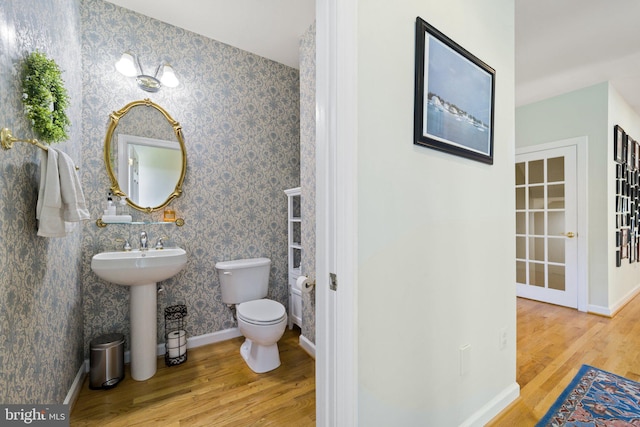 bathroom with sink, hardwood / wood-style flooring, and toilet