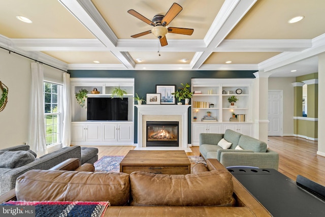 living room featuring ornamental molding, coffered ceiling, beam ceiling, and light hardwood / wood-style flooring