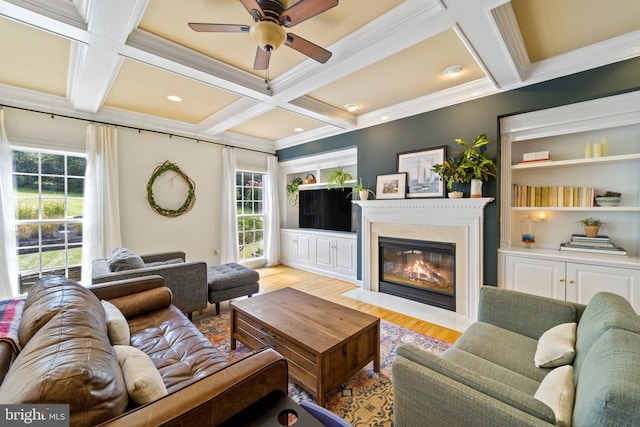 living room featuring crown molding, coffered ceiling, beam ceiling, and light wood-type flooring