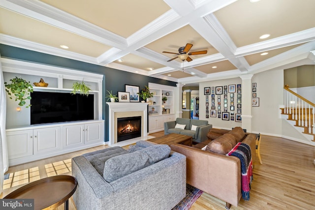 living room with coffered ceiling, light hardwood / wood-style flooring, ornamental molding, beam ceiling, and decorative columns