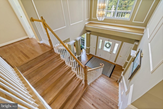 foyer entrance with a chandelier and light wood-type flooring