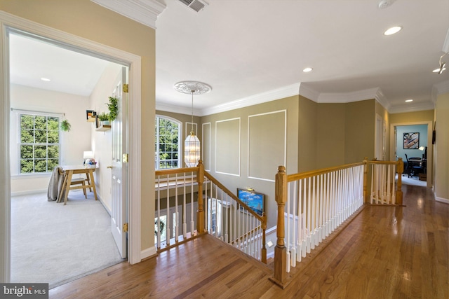 hall featuring ornamental molding and wood-type flooring